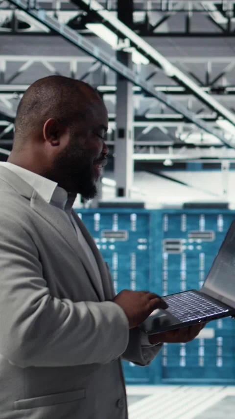 Vertical video Data center engineer deploying AI driven management tools using Stock Footage 311547979