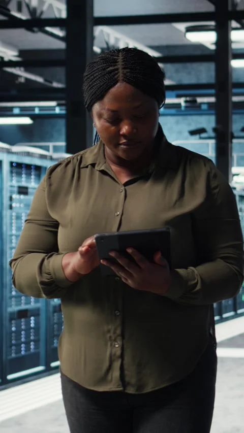 Vertical video Data center engineer using app on tablet to ensure error free Stock Footage 317055732