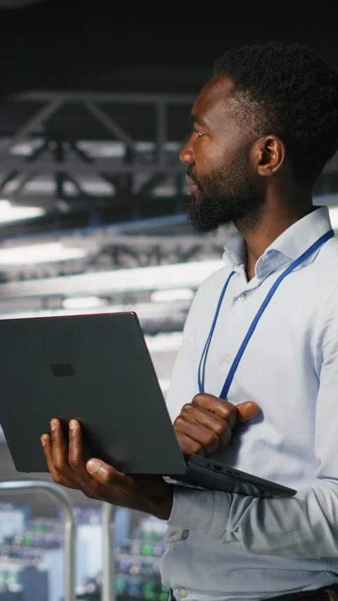 Vertical video Data center engineering team on industrial platform collaborating Stock Footage 310771544