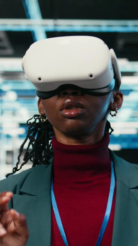 Vertical video Data center female engineer putting VR glasses on to do gear rigs Stock Footage 329649808
