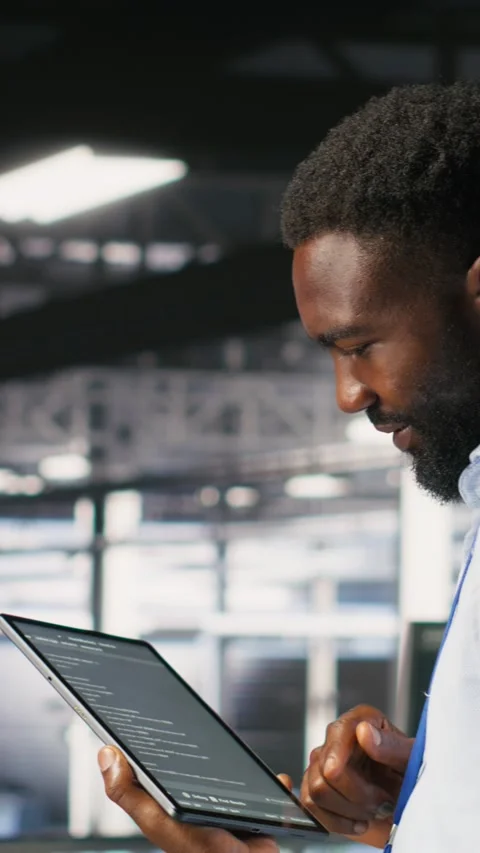 Vertical video Data center programmer checking lines of code next to colleague Stock Footage 310773107