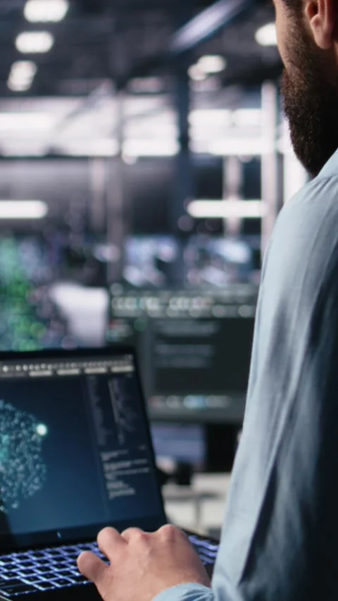 Vertical video Data center programmer using laptop to monitor neural network Video stock 313455932