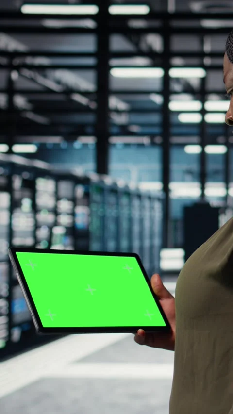 Vertical video Data center programmer uses green screen tablet to minimizing Stock Footage 316857296