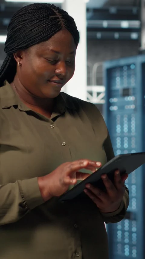 Vertical video Data center programmer monitors data center metrics on tablet Stock-Footage 317055501