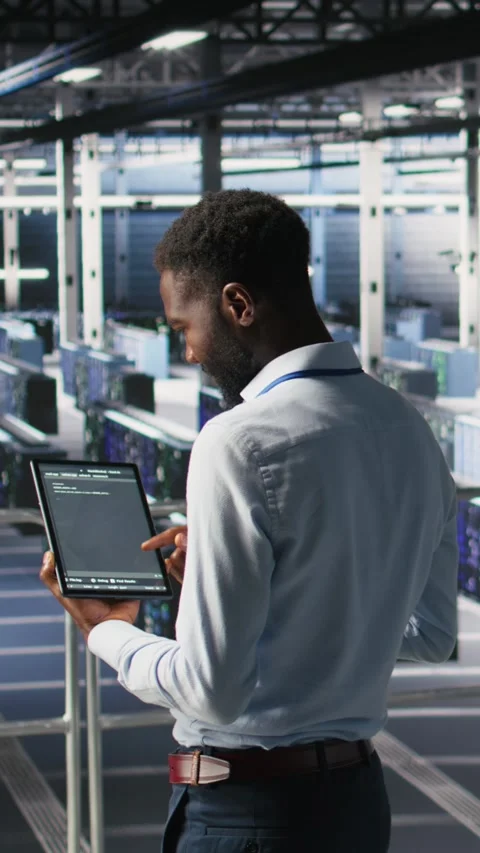 Vertical video Data center programmers on industrial platform checking lines of Stock Footage 310780412