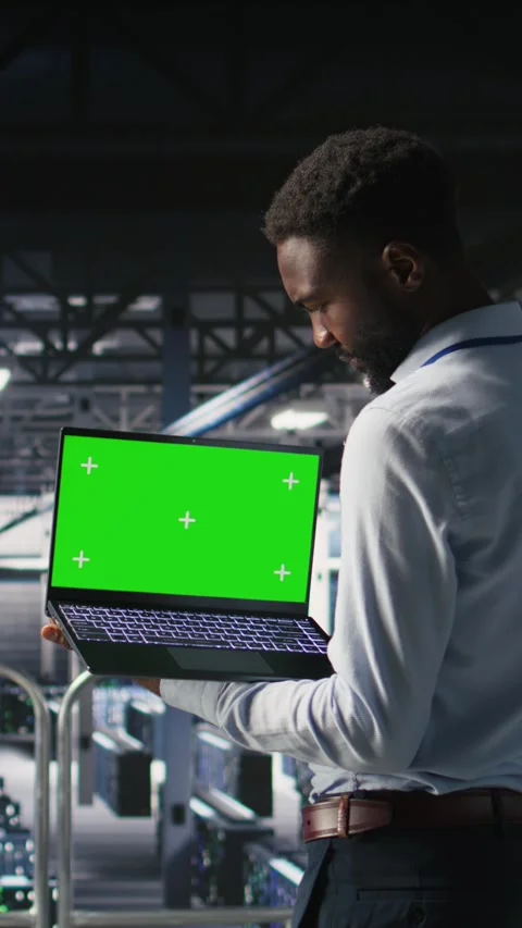 Vertical video Data center programmers on industrial platform using green screen Stock Footage 310780573