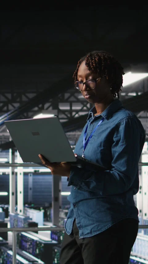 Vertical video Data center software developers using devices to review AI LLM Stock Footage 310778149