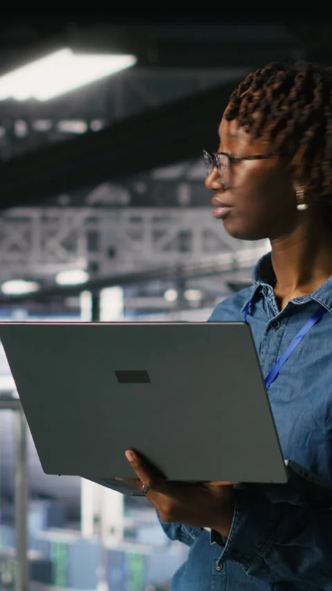 Vertical video Data center software developers using devices to review AI LLM Stock Footage 310778268