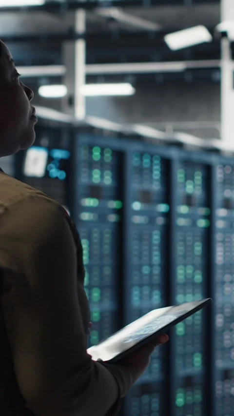 Vertical video Data center software developer doing AI data analysis on tablet Stock Footage 316861891