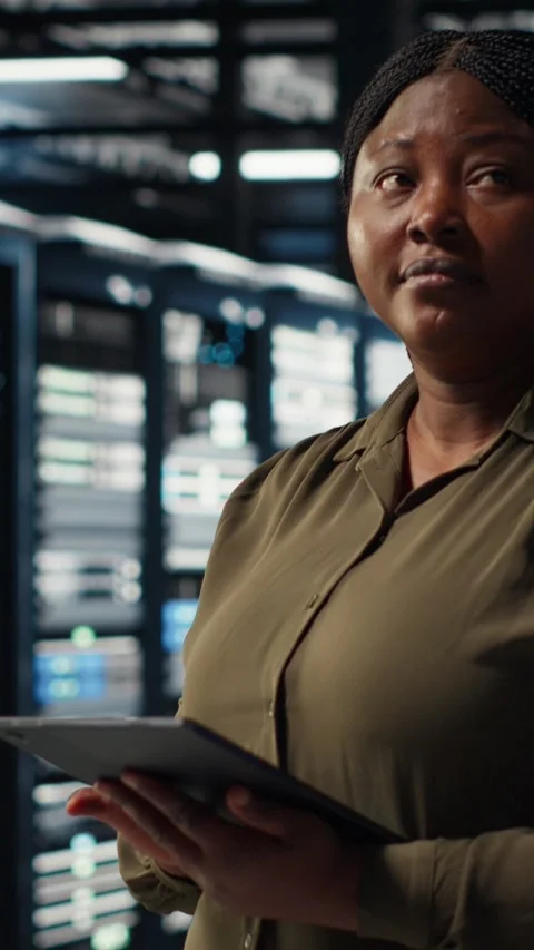 Vertical video Data center software developer uses tablet to develop disaster Stock Footage 317054669