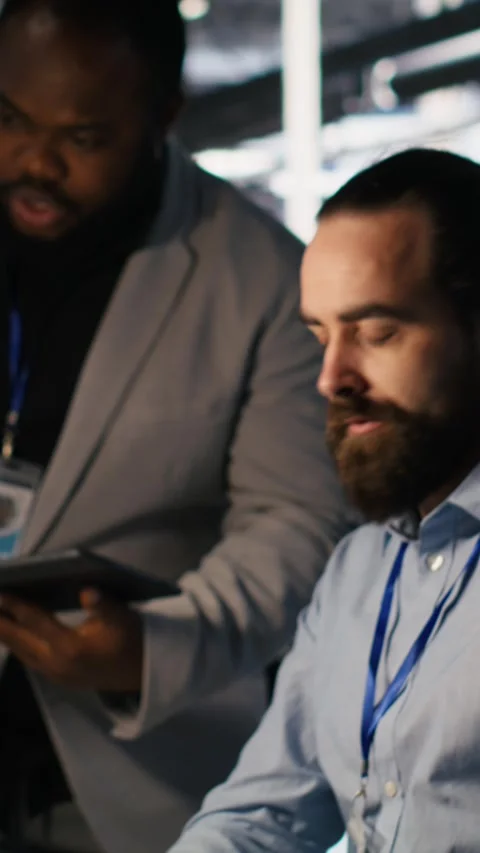Vertical video Data center system administration team collaborating on AI Stock Footage 309258030