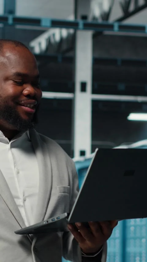 Vertical video Data center system administrator reviewing code for automation Stock Footage 311339738