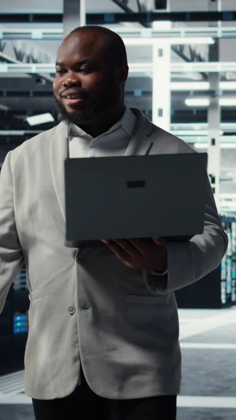 Vertical video Data center system administrator reviewing code for automation Stock Footage 311413297