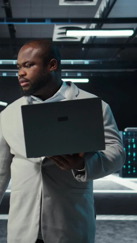 Vertical video Data center system administrator coding on laptop, doing software Stock Footage 311489019