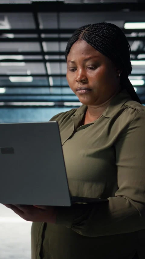 Vertical video Data center system administrator using laptop to ensure error Stock Footage 316859260