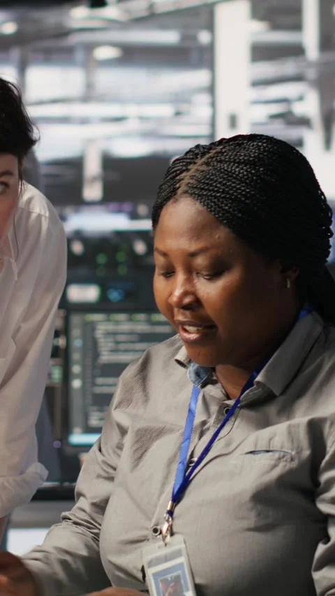 Vertical video Data center team leader and IT expert reviewing performance Stock Footage 309254436