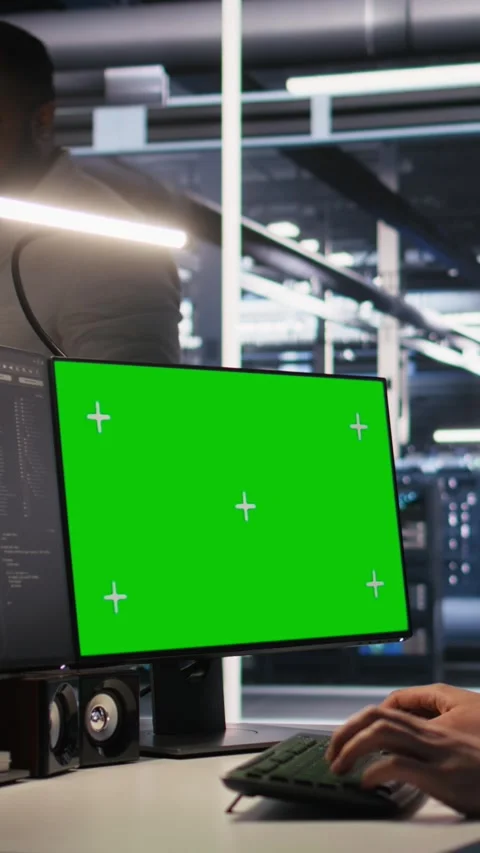 Vertical video Data center technician doing software updates using green screen Video stock 309487914