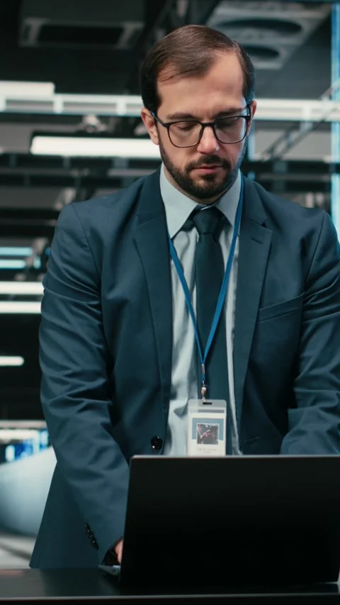 Vertical video Data center technician uses laptop and augmented reality to Stock Footage 329451234