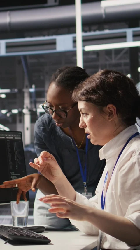 Vertical video Data center technicians adjusting blade server hardware powering Stock Footage 309255993