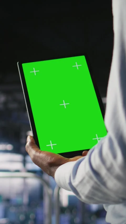 Vertical video Data center worker using green screen mockup tablet, doing Stock Footage 310777865