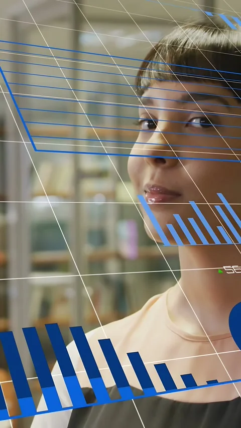 Vertical video: Data overlays tracking face causing woman in tech lab laughing Stock Footage 334046782