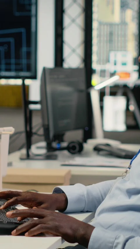 Vertical video Data scientist in office doing software development to launch new Stock Footage 323330965