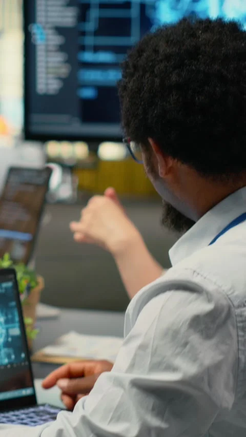 Vertical video Data scientists in startup office brainstorming leveraging AI Stock Footage 322696071
