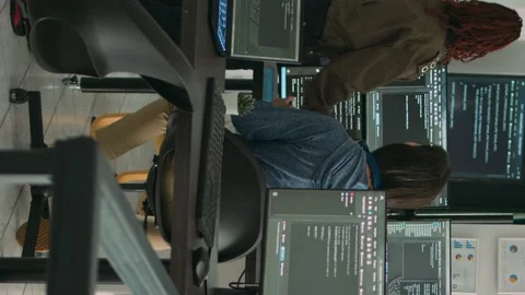 Vertical video: Database admins collaborating on group project compiling Stock Footage 220104609