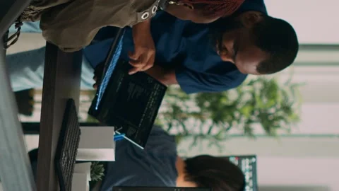 Vertical video: Database developer explaining algorithm to colleague coder Stock Footage 219702971