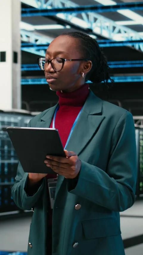 Vertical video Debugging systems, tablet and female engineer walking in data Stock Footage 329713727