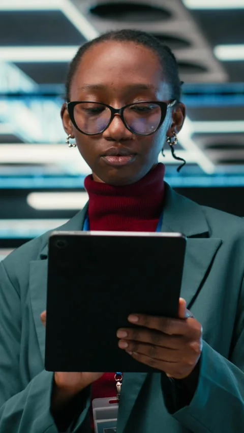 Vertical video Debugging systems, tablet and female engineer walking in data Stock Footage 329944186