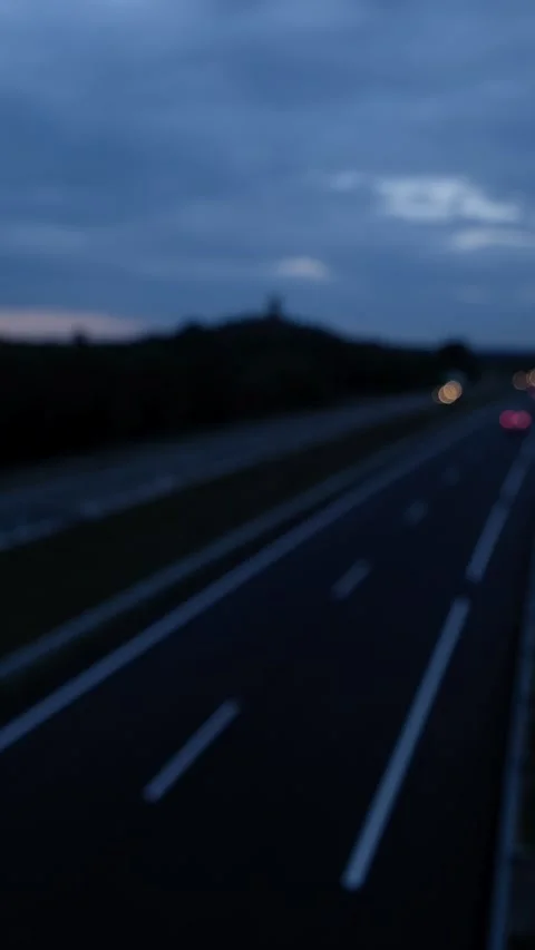 Vertical video defocused and blurred of cars driving along a highway at night 스톡 동영상 252814650
