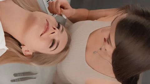 Vertical video demonstrates the skill professional eyelash lengthening artist Video stock 262341080