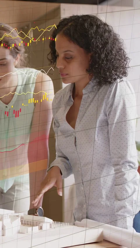 Vertical video: Design lead touching round knob, reviewing model with teammate, Stockbeeldmateriaal 333464938