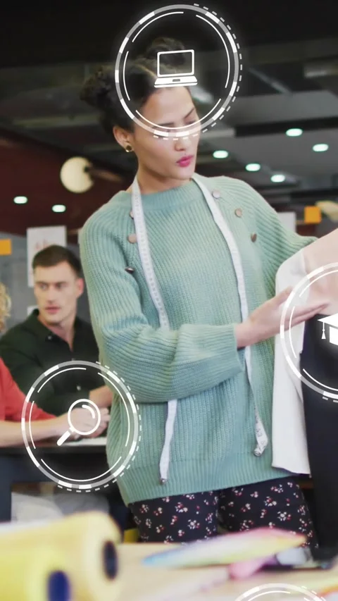Vertical video: Designer glancing at team, checking top with tape for fit, AR Stock Footage 334317509