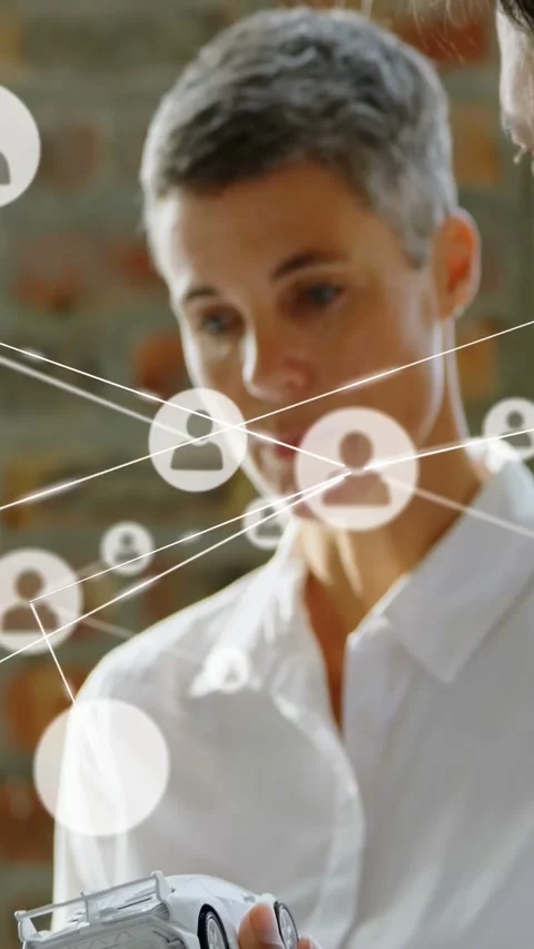 Vertical video: Designer holding car model tapping tablet causing node map Video stock 334024947