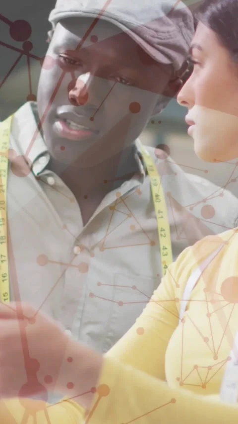 Vertical video: Designer holding swatch, tailor leaning and pointing with tape, Stock Footage 331703197