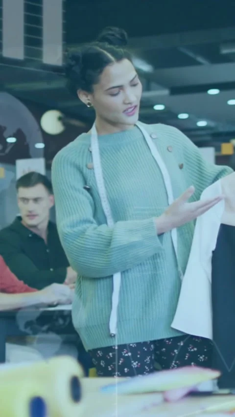 Vertical video: Designer lifting two-tone garment with tape, turning, checking 스톡 동영상 330395222