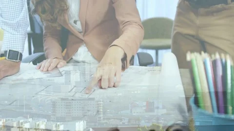 Vertical video: Designer pointing at plan, tracing, leading while city overlay Stock Footage 332804680