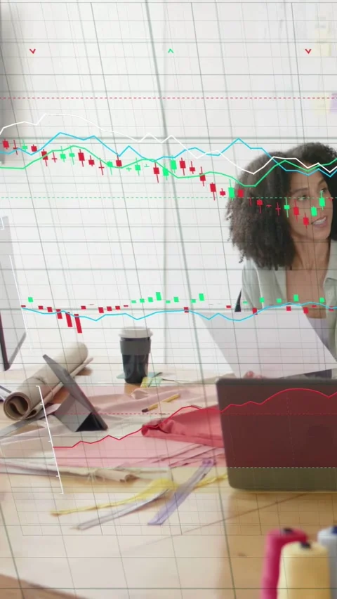 Vertical video: Designer scanning docs at desk while clear finance chart Stock Footage 333236355