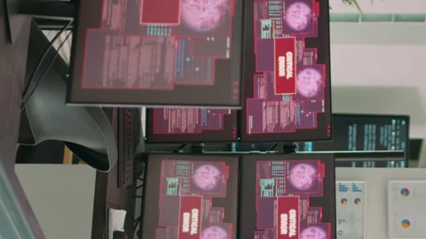 Vertical video: Desk with multiple monitors displaying error message on screen Video stock 219701755