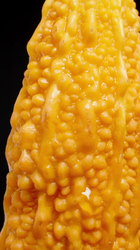 Vertical video. Detailed View of the Bitter Melon's Bumpy Surface, Rotating to Stock Footage 284319866