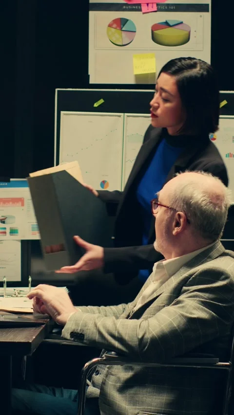 Vertical Video Detectives team comparing witness statements in investigations Stock Footage 265143106