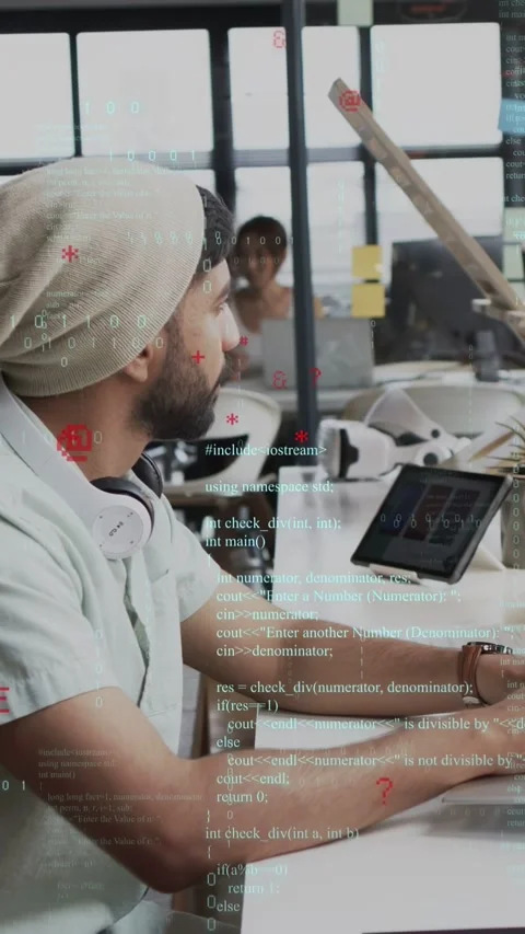 Vertical video: Dev coding on devices, code overlay on UI, peer at glass causing Video stock 335355221