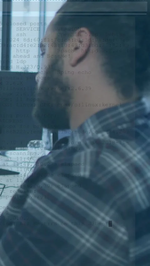 Vertical video: Dev leaning at desk, studying code for QA while monitor Stock Footage 329961748