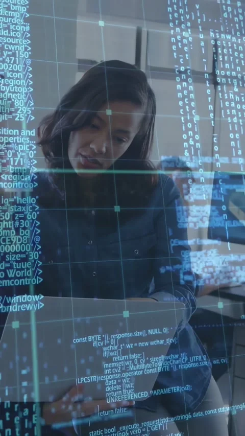 Vertical video: Dev leaning over laptop pointing and fixing bug, animated code Stock Footage 334187482