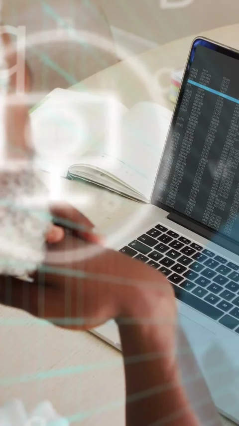 Vertical video: Dev sitting, reviewing code while terminal driving icons across Stock Footage 334046793