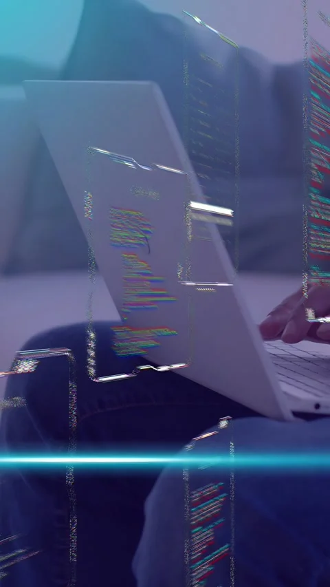 Vertical video: Dev typing on lap laptop causing code panels sliding with blue Stock Footage 335507618