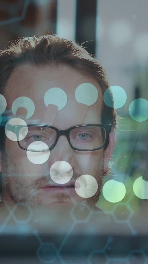 Vertical video: Dev working at screen, code popping, sparking hex grid on face, Stock Footage 331178290