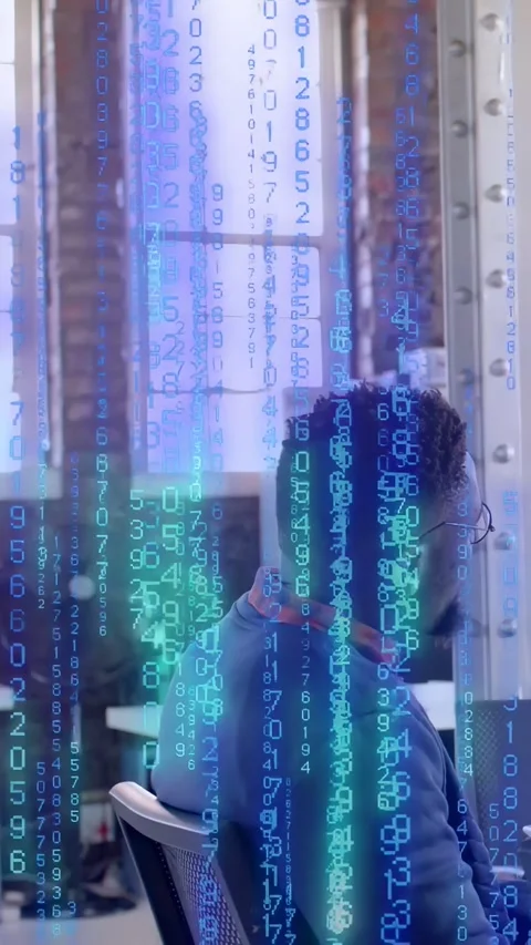 Vertical video: Developer leaning toward monitor while data feed creating code Stock Footage 333896037